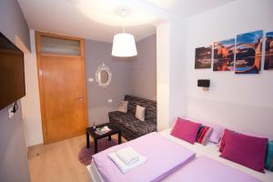 a small living room with a bed and a couch at Pansion Ponte in Mostar