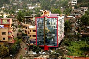 a building with a glass tower in the middle of a city at Hotel Grand Luit in Guwahati