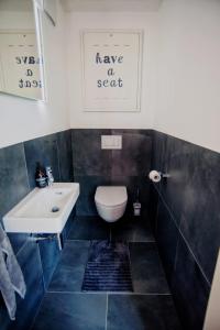 a bathroom with a toilet and a sink at SPA Boutique Appartement # 26 with Indoor- and Outdoorpool in Neusiedl am See