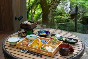 a wooden table with a tray of food on it at Villa Hamorebi in Miyajima