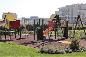 a playground in a park with a swing set at Atia Resot in Chernomorets