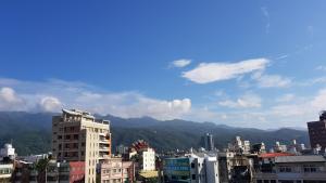 vistas a una ciudad con edificios y montañas en Toucheng Homestay en Toucheng