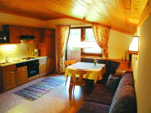 a kitchen with a table and a couch and a table at Feriengut Lackenhof in Filzmoos