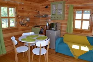 a kitchen and dining room with a table and chairs at Le Jardin des Pierres Brunes in Saint-Jean-des-Ollières