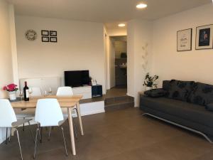 a living room with a table and a couch at Apartment Vita in Funtana