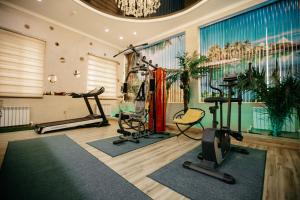 a gym with exercise equipment in a room at Hotel KARAVAN in Urganch