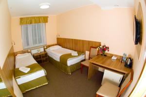 En eller flere senge i et værelse på Leśny Ośrodek Szkoleniowy