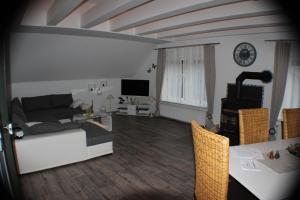 a living room with a couch and a table at Ferienhaus Abbi mit Schwimmbad und Fitness für 8 Personen, Strand, Norddeich in Hage