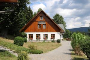 a large building with a wooden roof at Hotel Gabriela in Vítkovice