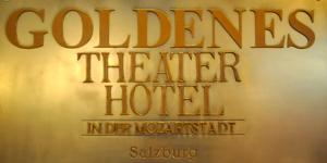a sign with a picture of a man on it at Goldenes Theater Hotel Salzburg in Salzburg