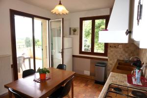 a kitchen with a wooden table and a dining room at Gite Villa des Sources in Les Granges-Gontardes +22 photos