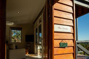 a door to a house with a sign on it at Vivere Retreat in Neerim South