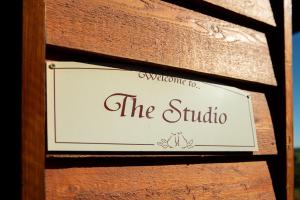 a sign for the studio on a wooden wall at Vivere Retreat in Neerim South