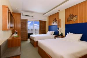 A bed or beds in a room at BE Resort Mactan