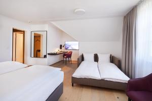 
Ein Bett oder Betten in einem Zimmer der Unterkunft Hotel Gasthof zum Ochsen
