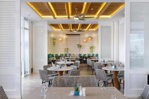 a dining room with tables and chairs at BE Resort Mactan in Mactan