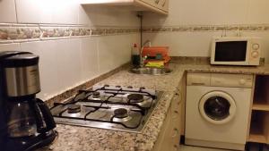 A kitchen or kitchenette at Apartamentos Timón Puerto