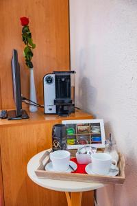 a tray with bowls and cups on a table at Penzion U Jezku in Blansko