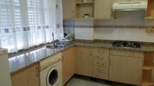 A kitchen or kitchenette at Apartamentos Timón Puerto