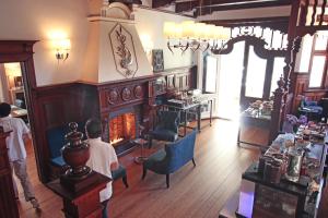 two boys sitting in a room with a fireplace at Hotel Villa WellenRausch in Travemünde