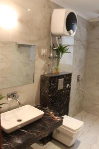 a bathroom with a sink and a toilet and a mirror at Hotel Aero Star Near Delhi Airport in New Delhi