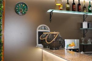 a counter with two vases and a clock on a wall at Park Hotel Briz - All Inclusive & Free Parking in Golden Sands