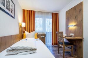 Postel nebo postele na pokoji v ubytování Hotel Das Schlossberg superior