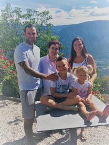 a family posing for a picture on a bench at Residence Liesy in Tesimo