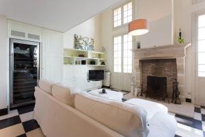 a living room with a couch and a fireplace at La Petite Fontaine in Théoule-sur-Mer