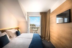 Ein Bett oder Betten in einem Zimmer der Unterkunft Remisens Hotel Epidaurus-All inclusive