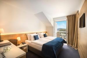 Ein Bett oder Betten in einem Zimmer der Unterkunft Remisens Hotel Epidaurus-All inclusive