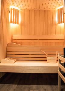 a sauna with a bench in a wooden room at La villa 10 HÔTEL SPA in Étretat