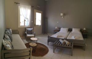 a living room with two beds and a couch at Kiki Studios in Fiskardo