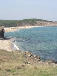 a beach with a group of people in the water at Sweet Suite Sinemorets in Sinemorets