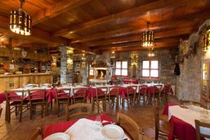 a restaurant with tables and chairs in a room at Tourist farm Tonin in Šmarje