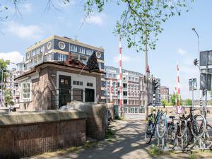 a building with bikes parked in front of it at SWEETS - Van Hallbrug in Amsterdam