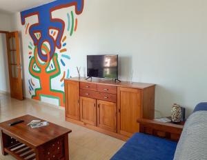 a living room with a tv on top of a cabinet at Apartamento ARENA en Santa Cruz de la Palma in Santa Cruz de la Palma