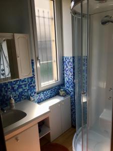 a bathroom with a shower and a sink and a tub at Baia del Re da joli e Amedeo Lago Maggiore in Minusio