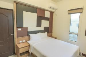 Postel nebo postele na pokoji v ubytování Sing Fu Hua Homestay + 7 fotografií