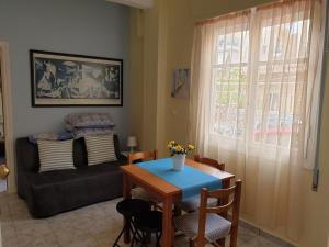 een woonkamer met een tafel en een bank bij Tolis Apartments in Preveza