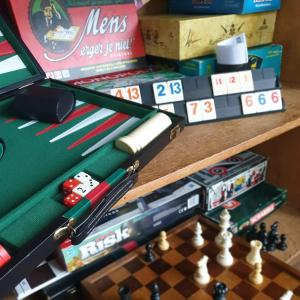 a chessboard and playing cards on a table at Sonnevanck Wijk aan Zee in Wijk aan Zee