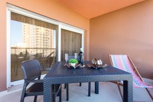 a dining room with a table and chairs and a window at Litoralmar beachfront apartment in Portimão