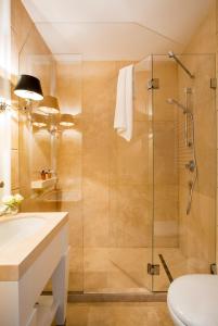a bathroom with a shower and a toilet and a sink at Residenza B in Rome