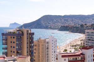 a view of a beach and buildings and the ocean at Apartamentos Colón - Grupo Antonio Perles in Calpe