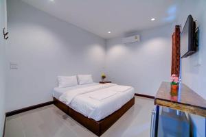 a bedroom with a bed and a television in it at The Sleep Resort in Chiang Mai +17 photos