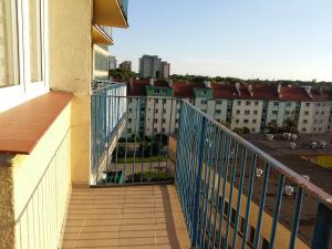 a balcony with a view of a city at Apartament Ostrowskiego in Wrocław