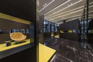 a lobby with a chair on a yellow table at the base in Pattaya