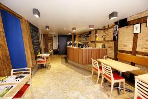 a restaurant with wooden tables and chairs and a counter at ô ChÔmière in Stavelot