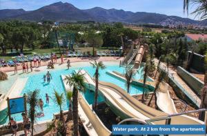 a water park at a resort with palm trees and slides at Inmosantos Oasis F5 in Roses