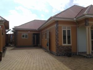 a house with a brick driveway in front of it at FREEDOM Guest House in Wakiso